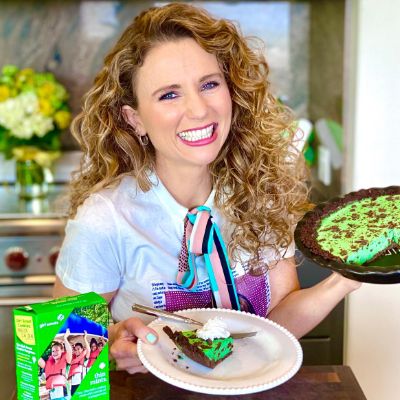 Audrey Dunham holding St. Patrick's Day-themed pie.